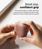 AirPods 5 / 4 Case | Onyx Magnetic - Hands holding a textured, dusty rose AirPods 4 case with side grip detailing.