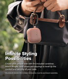 AirPods 5 / 4 Case | Onyx Magnetic - A dusty rose AirPods 4 case with a carabiner attached to a black handbag held by a person.
