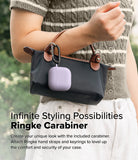 AirPods 5 / 4 Case | Silicone Case - AirPods 4 Case - A light purple silicone AirPods 4 case attached to a black handbag with a metal carabiner.