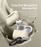 AirPods Pro 2 Case | Silicone - Cream-colored silicone case for AirPods Pro 2 with a black carabiner against a liquid splash.