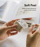 AirPods Pro 2 Case | Silicone - Hands holding a beige silicone AirPods Pro 2 case with one earbud removed.