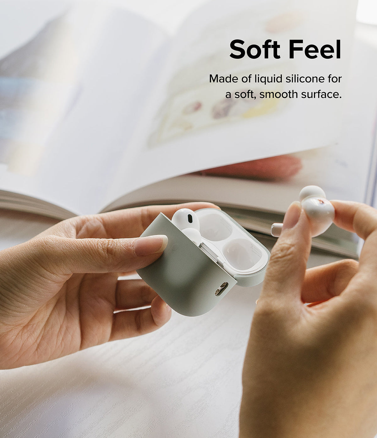 AirPods Pro 2 Case | Silicone - Hands holding an open sage green silicone case with white AirPods Pro 2 earbuds.