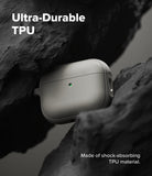 AirPods Pro 3 Case | Onyx Magnetic - Grey textured AirPods Pro case nestled between dark, jagged rocks with a green LED.
