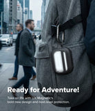 AirPods Pro 3 Case | UX Magnetic - Black protective case with carabiner clipped to a grey backpack in a city setting.