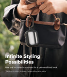 AirPods Pro 3 Case | UX Magnetic - Black protective case with carabiner attached to a handbag held by a person.