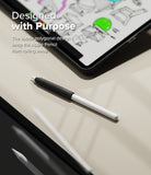 Apple Pencil Case | Silicone Drafting Grip Holder - Black silicone grip on an Apple Pencil resting on a desk near a tablet.