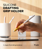 Apple Pencil Case | Silicone Drafting Grip Holder - Apple Pencil Case - Hand holding an Apple Pencil with a yellow silicone drafting grip over a tablet on a wooden desk.