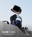 Apple Watch 12 42mm | Slim (2P) - Three slim protective cases for Apple Watch 12, 42mm are shown floating above a concrete ledge against a pale blue sky. The cases are in light pink, dark gray, and black, with the center case fitted on a watch.