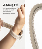 Apple Watch 42·41·40·38 mm | Sports Air Loop - A hand adjusting a textured, cushioned beige watch band on a wrist.