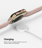 Apple Watch Series 6 / 5 / 4 / SE (44mm) | Full Frame - Gold Apple Watch case with pink band hovering over a wireless charger.
