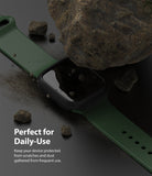 Apple Watch 9 / 8 / 7 (41mm) | Slim - Green watch band and black protective case under a rock with scattered debris.