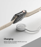 Apple Watch 9 / 8 / 7 (41mm) | Slim - Apple Watch with a slim black protective case hovering above a wireless charging puck.