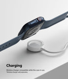 Apple Watch 9 / 8 / 7 (45mm) Case | Slim - A dark blue Apple Watch with a slim case hovering above a white wireless charger.