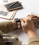 Apple Watch 49·46·45·44·42 mm | Metal One Band - Person wearing a silver metal link band on an Apple Watch while typing.