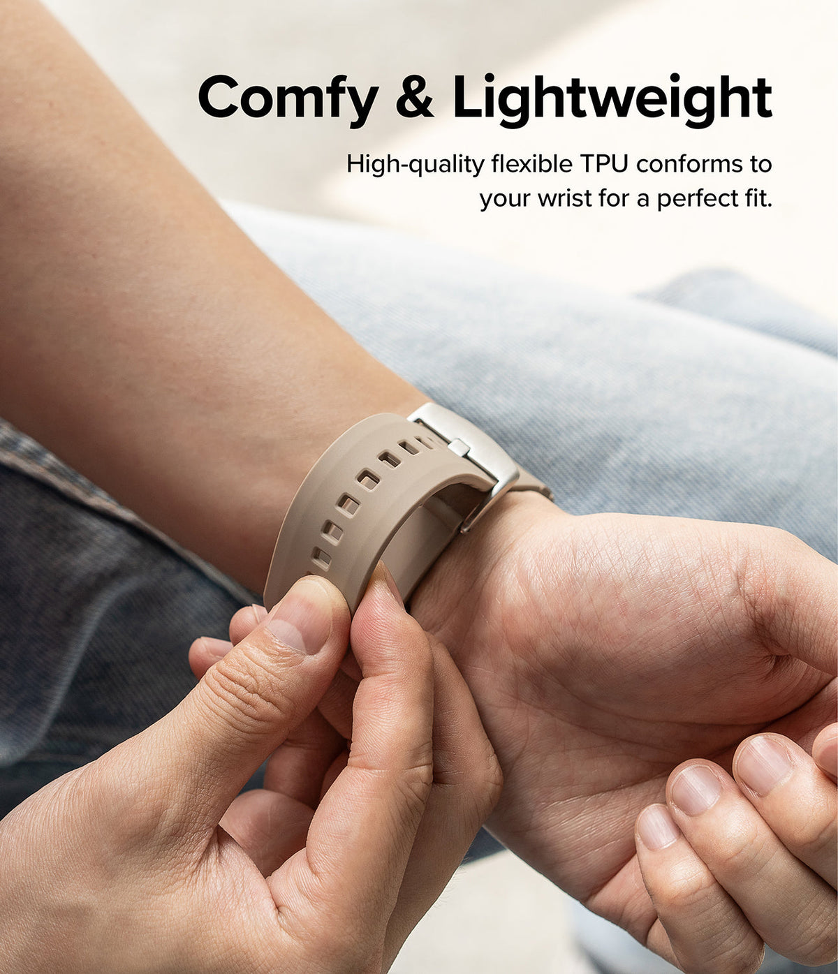 Apple Watch 49·46·45·44·42mm | Rubber One Bold Band - A hand pulls on a flexible, beige TPU watch band worn on a wrist.