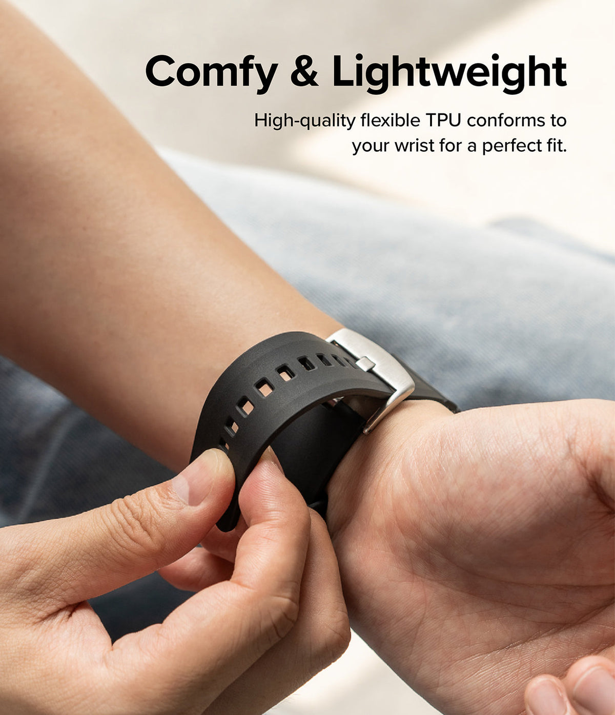 Apple Watch 49·46·45·44·42mm | Rubber One Bold Band - Hand adjusting a flexible black TPU watch band on a wrist.