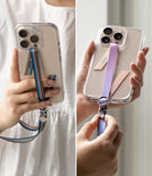 Band Buckle Circle Type Strap - Two hands holding phones with colorful fabric straps featuring metal ring and charm accents.