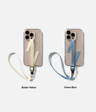 Band Buckle Rectangle Type Strap - Two phones with butter yellow and urban blue fabric wrist straps featuring floral charms.