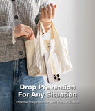 Band Buckle Rectangle Type Strap - A phone with a cream-colored strap attached to a canvas tote bag held by a person.