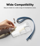 Band Buckle Rectangle Type Strap - Hand attaching a beige adhesive strap to a clear phone case with a blue wrist strap.