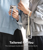 Band Buckle Rectangle Type Strap - Two people wearing phones on their wrists using adjustable fabric straps with buckles.