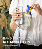 Band Buckle Rectangle Type Strap - A person holding a phone with a blue wrist strap and a green gingham pouch.