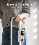 Band D Ring Hand Hook Strap - A person holding a suitcase handle with a phone and small pouch attached via a D-ring strap.
