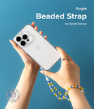 Beaded Strap - Hands holding a glittery phone case with a blue and yellow beaded wrist strap against a blue background.