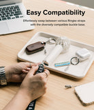 Strap Buckle Base | Light Gray [2 Pack] - Strap Buckle Base - Hands attaching a strap to a portable fan on a desk tray with other accessories.