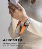 Cam Buckle Hand Strap - Person wearing a watch with an orange strap and holding a phone, on a plain background.