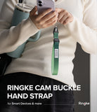 Cam Buckle Hand Strap - Person holding a phone with a green Ringke cam buckle hand strap visible.