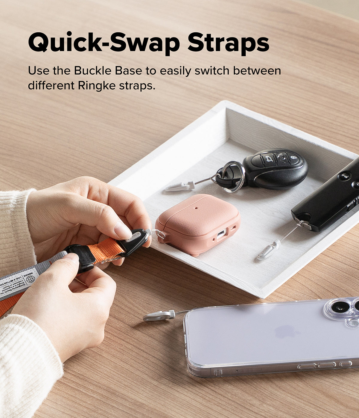 Cam Buckle Hand Strap - Quick-Swap Straps product with hands using a buckle base on a wooden surface.