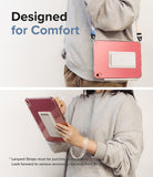 Fusion + Outstanding | iPad - Person wearing a pink iPad case with a built-in stand and carrying strap for hands-free use.