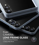 Galaxy Z Flip 7 FE | Camera Lens Frame Glass (2 Pack) - Camera Lens Frame Glass - Two black camera lens protectors being applied to a foldable smartphone.