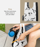 Day-Me Bag - A white tote with black dog illustrations, shown folded and in use with a blue retractable dog leash.