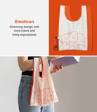 Day-Me Bag - White tote with orange trim and cute doodle faces, shown flat with a pouch and held by a person.