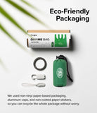 Day-Me Bag - Eco-friendly packaging, green foldable bag, carabiner, and clips on a white background with palm leaf shadow.