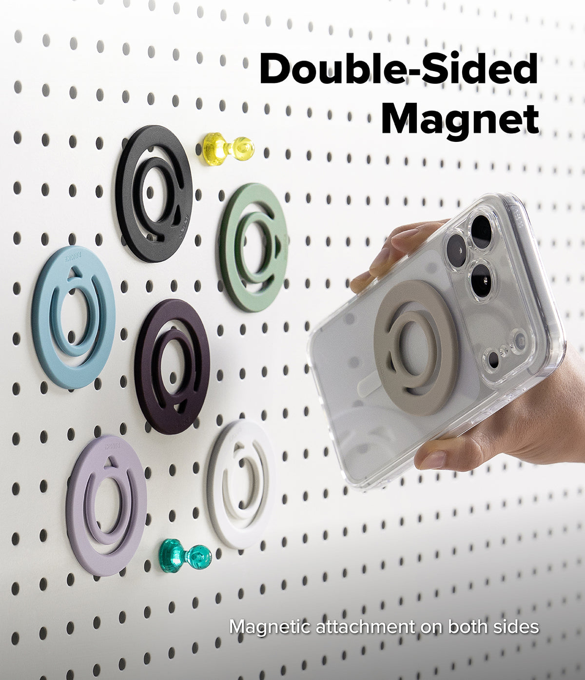 Dual Magnetic Silicone Ring - A clear smartphone case with a double-sided magnetic ring holder is shown being held by a hand against a white pegboard. The text reads 'Double-Sided Magnet' and 'Magnetic attachment on both sides,' with several colored magnetic rings displayed on the board.
