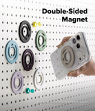 Dual Magnetic Silicone Ring - A clear smartphone case with a double-sided magnetic ring holder is shown being held by a hand against a white pegboard. The text reads 'Double-Sided Magnet' and 'Magnetic attachment on both sides,' with several colored magnetic rings displayed on the board.