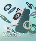 Dual Magnetic Silicone Ring - A clear smartphone case with a dark brown magnetic ring holder, shown floating on a light blue gradient background with several colorful ring accessories floating around it.