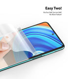 Redmi Note 9 Pro / 9 Pro Max Screen Protector | Dual Easy Film - Redmi Note 9 Pro / 9 Pro Max Screen Protector - Hand applying a clear protective film onto a smartphone screen.