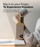 Holder Link Flow Finger Ring - A hand holds a white tumbler while a smartphone hangs from a beige finger strap attached to the wrist.