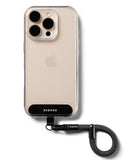 Holder Link Flow Finger Ring - A beige smartphone in a clear case attached to a black braided wrist strap finger ring.