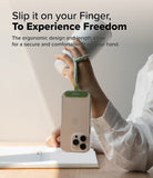 Holder Link Flow Finger Ring - A hand holds a white tumbler while a phone hangs from a green finger strap attached to the case.