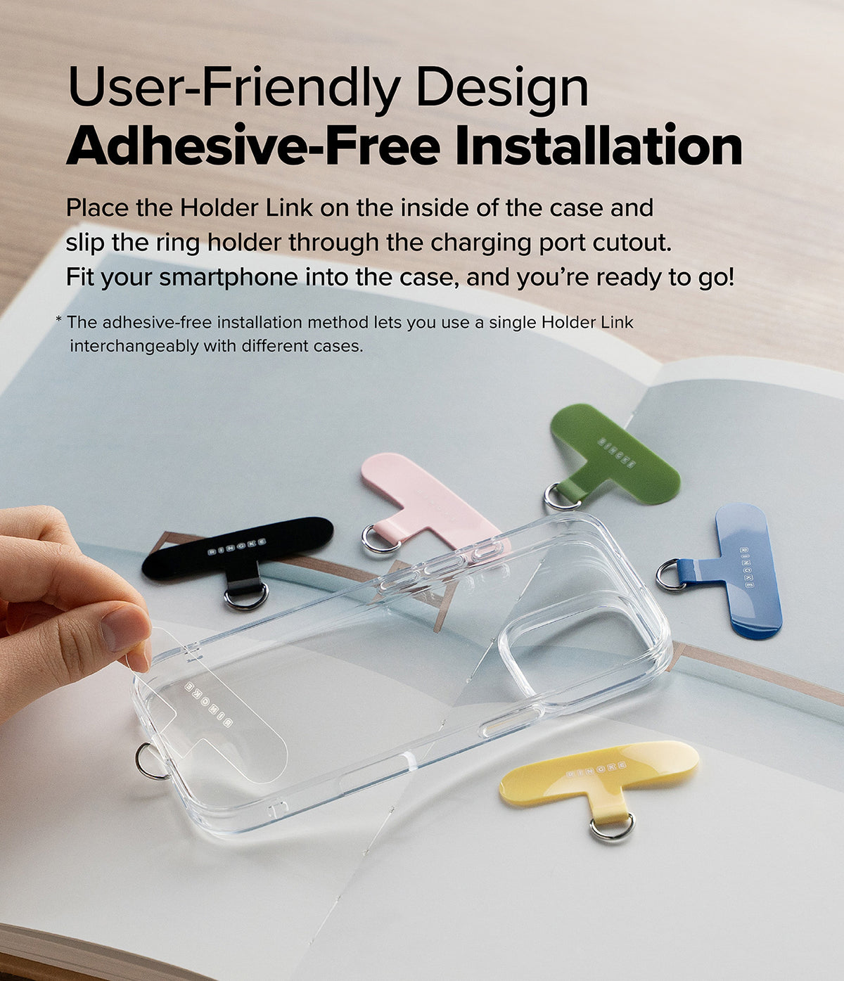 Holder Link Flow Finger Ring - Hand placing a colorful T-shaped ring holder inside a clear phone case with others nearby.