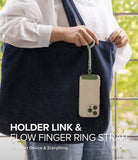 Holder Link Flow Finger Ring - A person holding a phone attached to a green finger ring strap hanging from a denim tote bag.