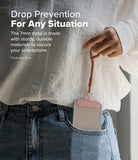 Holder Link Flow Finger Ring - A person holding a pink smartphone finger strap attached to a phone tucked in a jeans pocket.