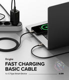 Ringke Fast Charging Basic Cable USB-C to USB-C - Black braided cable connecting a wall charger to a smartphone.