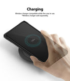 Galaxy S10 Lite Case | Fusion-X - A hand places a phone in a black case onto a wireless charger, showing 100% battery status.