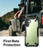 Galaxy A14 Case | Fusion-X - A rugged black and clear phone case held by a driver in an off-road vehicle.